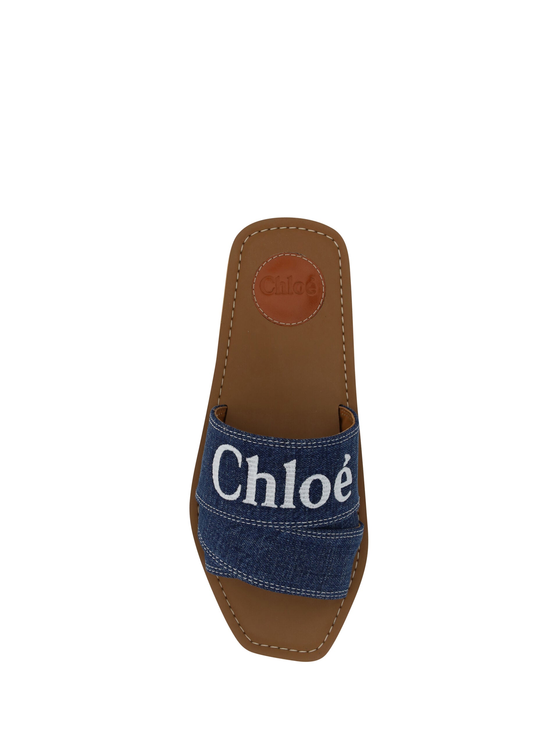 Chloé denim blue cotton slides with woody sandal soles, showcasing casual and comfortable footwear design.