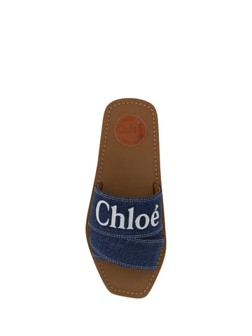 Chloé denim blue cotton slides with woody sandal soles, showcasing casual and comfortable footwear design.