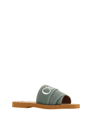 Forest green cotton slides by Chloé with woody sandal soles, featuring a casual slip-on design and comfortable open-toe style.
