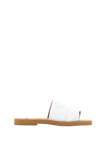 White cotton slide sandals by Chloé featuring a simple, comfortable design with a flat sole and minimalist style.