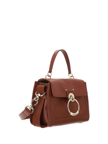 Chloé Tess handbag made of brown calf leather with top handle and gold hardware, showcasing elegant craftsmanship.