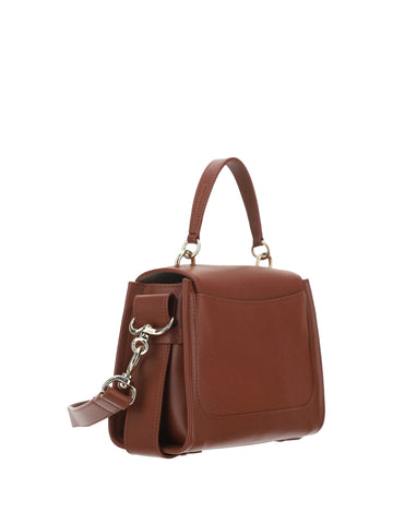 Brown calf leather Tess handbag by Chloé with structured shape and top handles, detailed stitching, and minimalist design.