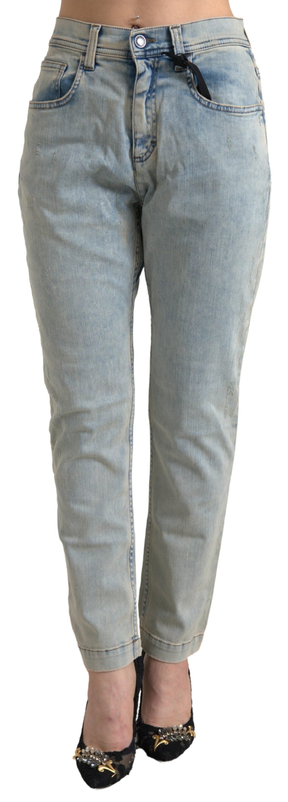 Blue washed cotton mid waist skinny jeans by Dolce & Gabbana, displayed on a hanger with detailed stitching and classic denim texture.