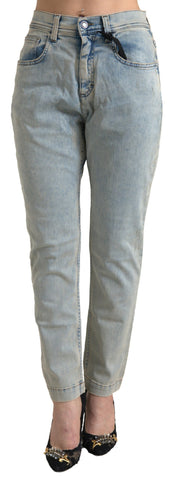 Blue washed cotton mid waist skinny jeans by Dolce & Gabbana, displayed on a hanger with detailed stitching and classic denim texture.