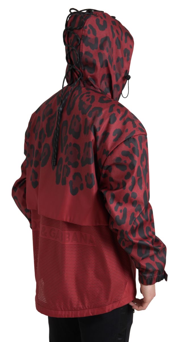 Red leopard print hooded rain coat jacket by Dolce & Gabbana, featuring a stylish hood and vibrant animal pattern.