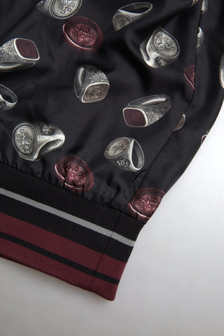 Black silk crewneck sweater with ring print design by Dolce & Gabbana, shown on a plain background.