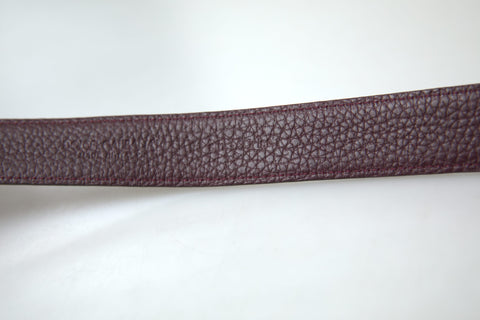 Brown leather men's belt with metal buckle from Dolce & Gabbana, featuring a sleek design and adjustable strap.
