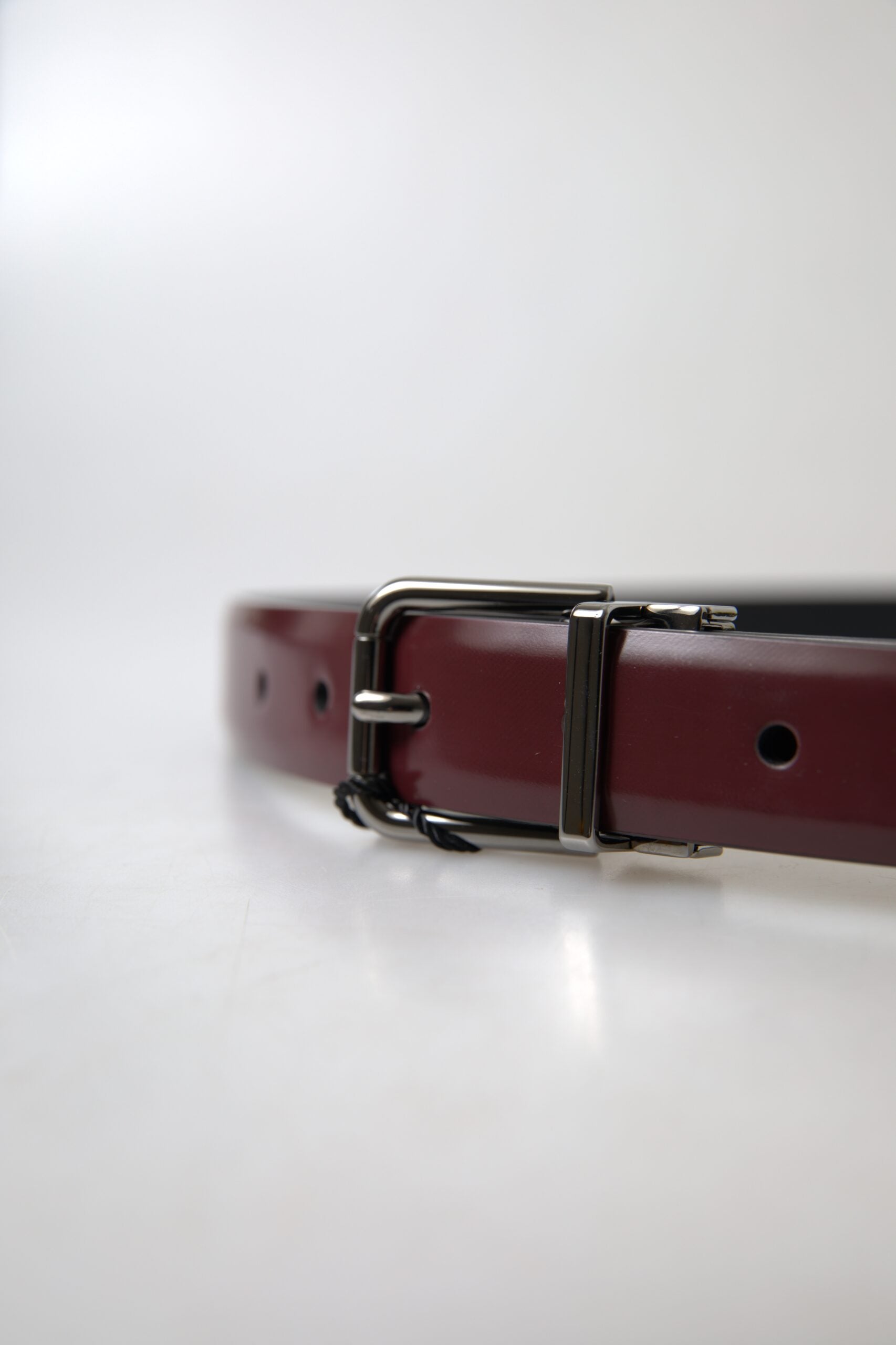 Dolce & Gabbana Bordeaux leather belt with silver metal buckle, stylish accessory for men or women.