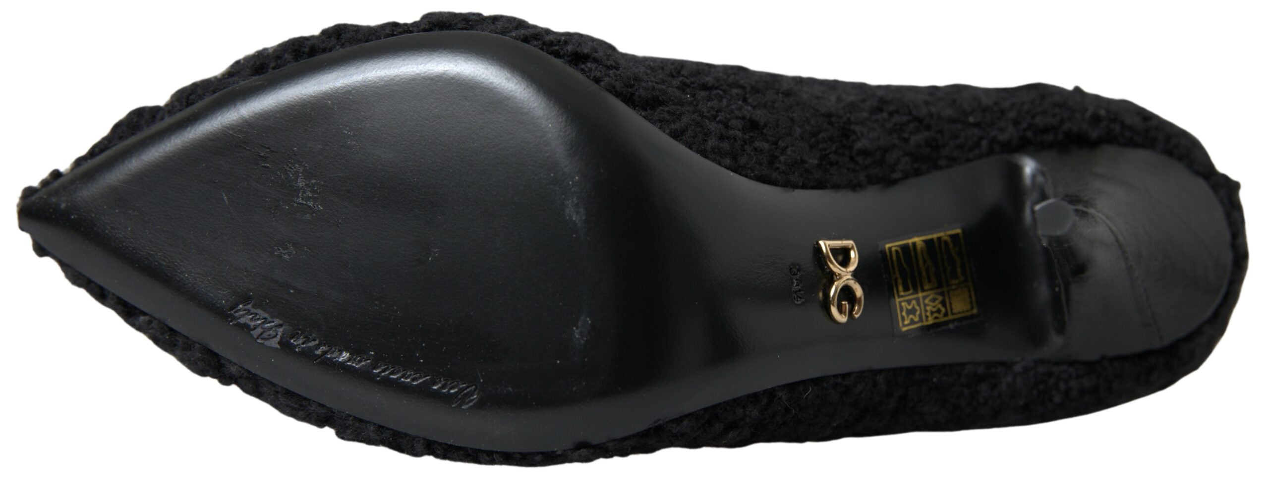 Black stiletto heels and mid-calf boots by Dolce & Gabbana, featuring sleek design and pointed toes.