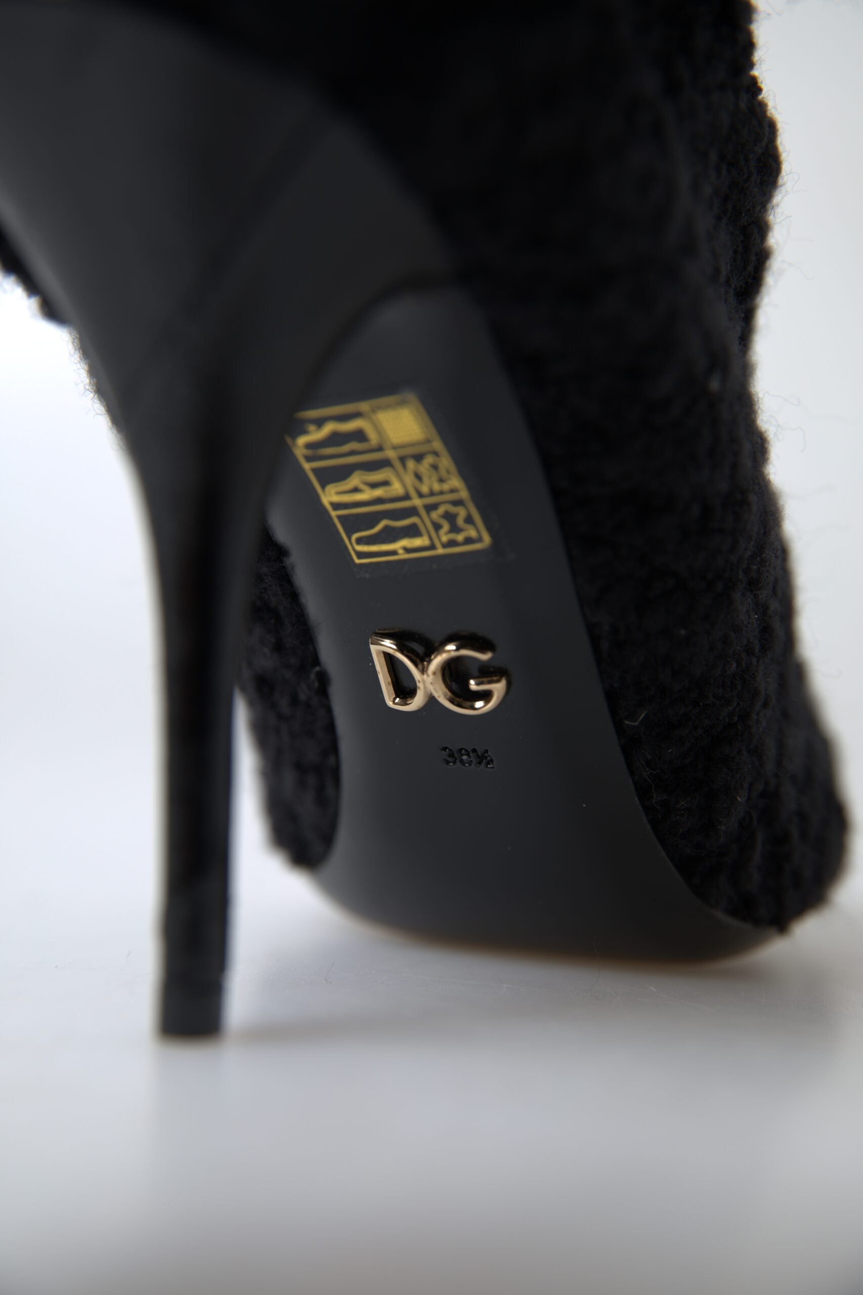 Pair of black stiletto heel mid-calf boots by Dolce & Gabbana, featuring smooth leather and sleek design.
