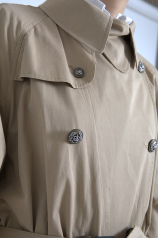 Dolce & Gabbana khaki double-breasted trench coat jacket with classic design and button details, shown on a plain background.