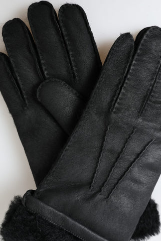 Black leather and fur short men's mittens gloves by Dolce & Gabbana, featuring a sleek design and soft fur trim.