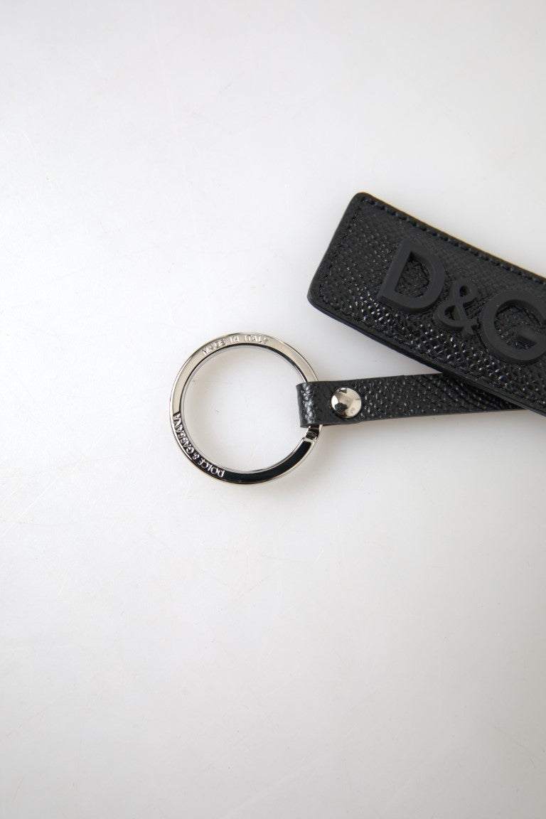 Black leather keychain with silver metal Dolce & Gabbana DG logo, featuring a sleek and stylish design.