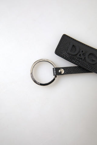 Black leather keychain with silver metal Dolce & Gabbana DG logo, featuring a sleek and stylish design.