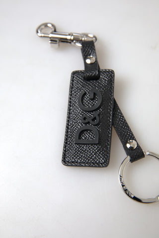 Black leather keychain with Dolce & Gabbana DG logo, silver metal accents, and a sleek, stylish design.