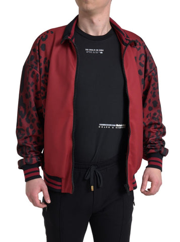 Red leopard print polyester bomber jacket with full zip closure by Dolce & Gabbana, shown on a hanger.