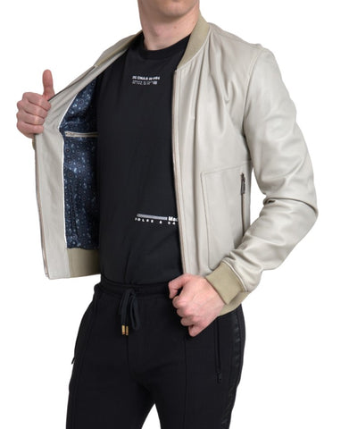 Cream leather bomber jacket with full zip closure from Dolce & Gabbana, featuring a classic bomber style and smooth leather texture.