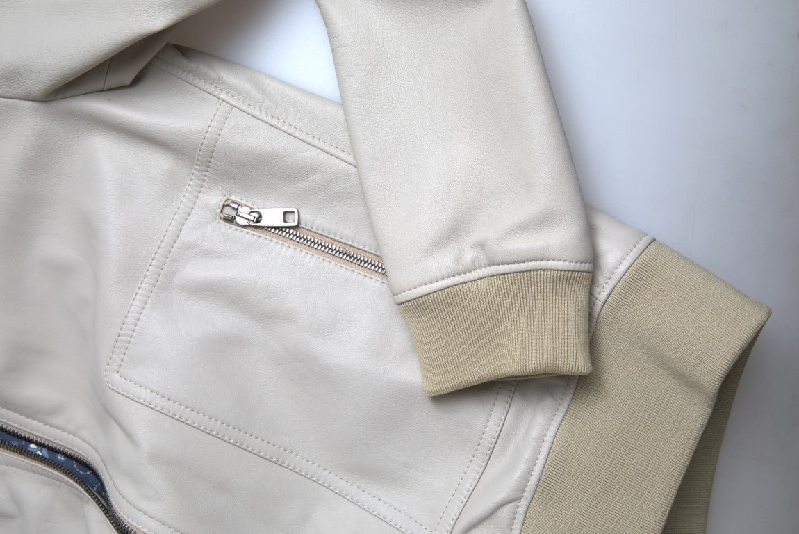 Cream leather bomber blouson jacket by Dolce & Gabbana, full zip front, with ribbed collar and cuffs, styled on a model.
