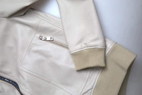 Cream leather bomber blouson jacket by Dolce & Gabbana, full zip front, with ribbed collar and cuffs, styled on a model.