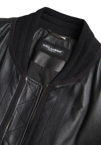 Black leather blouson full-zip bomber jacket by Dolce & Gabbana, shown on a mannequin with ribbed collar and cuffs.
