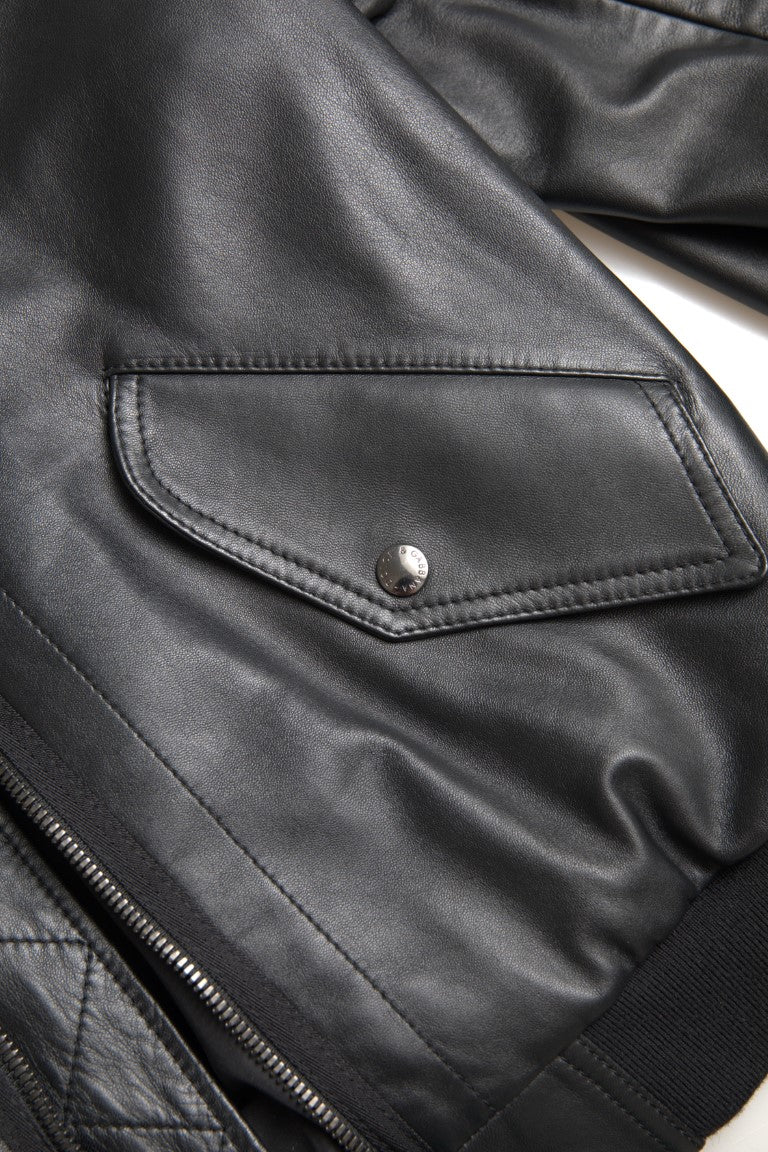 Dolce & Gabbana black leather blouson bomber jacket with full zip, stylish and sleek design, displayed on a hanger.