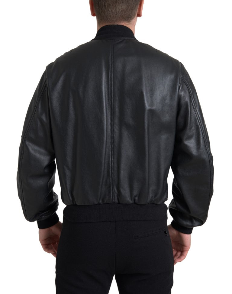 Black leather blouson bomber jacket with full zip and ribbed cuffs, by Dolce & Gabbana, shown on a neutral background.
