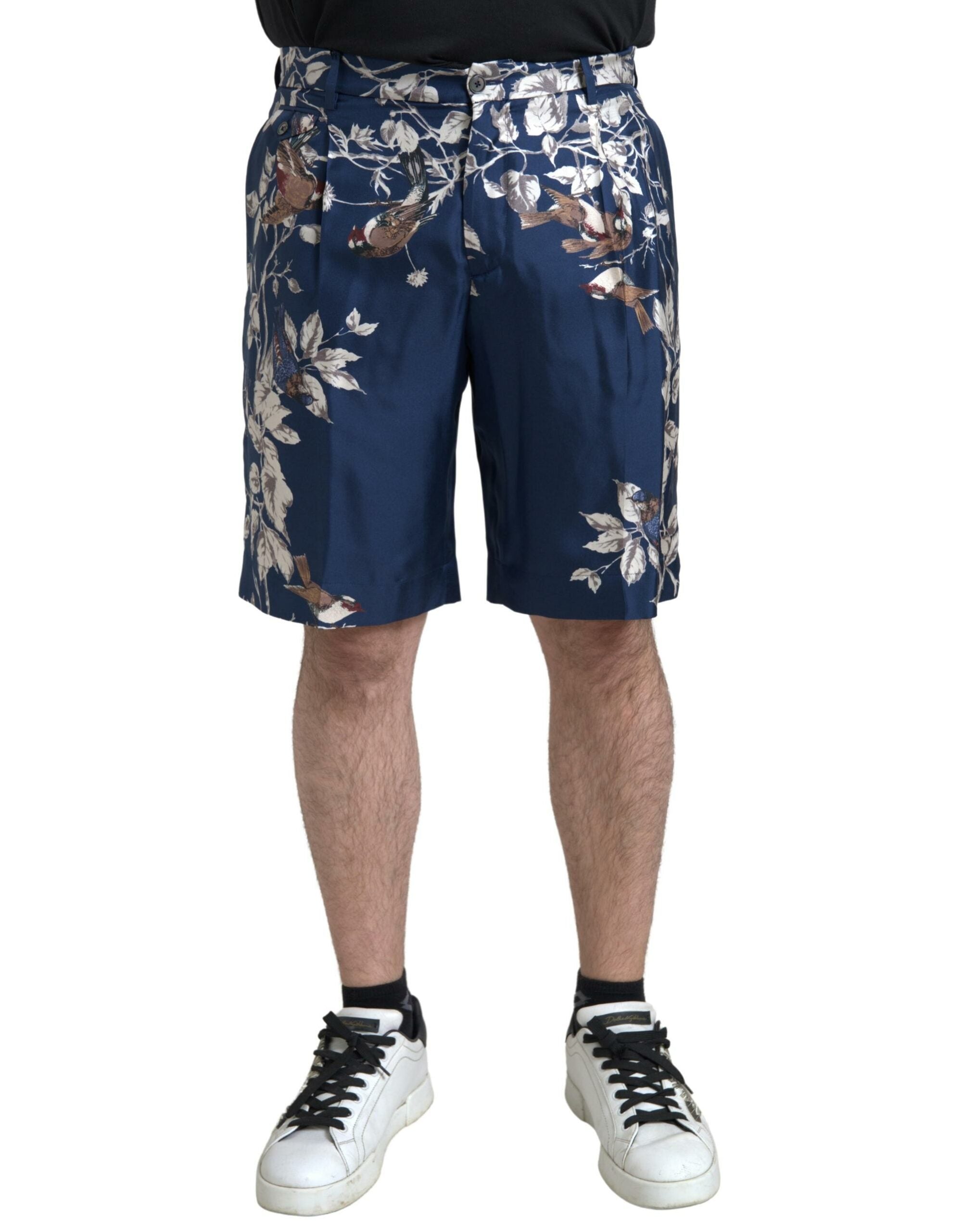Blue floral print silk Bermuda shorts for men by Dolce & Gabbana, featuring a stylish floral pattern and tailored fit.