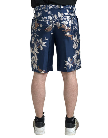 Blue floral print silk men's Bermuda shorts by Dolce & Gabbana, featuring a stylish floral pattern and relaxed fit.