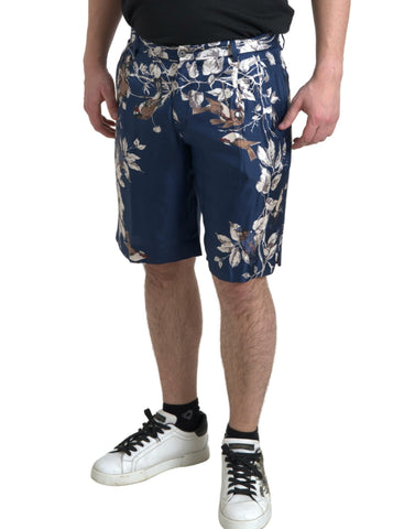 Blue floral print silk Bermuda shorts for men by Dolce & Gabbana, featuring a stylish floral pattern and tailored fit.