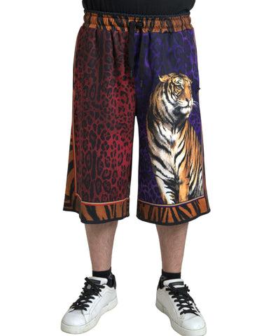 Multicolor tiger print men's Bermuda shorts by Dolce & Gabbana, featuring bold tiger pattern and casual fit.