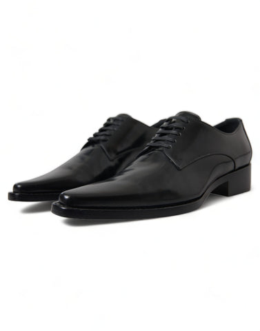 Black leather lace-up formal flats shoes by Dolce & Gabbana, featuring sleek design and polished finish.