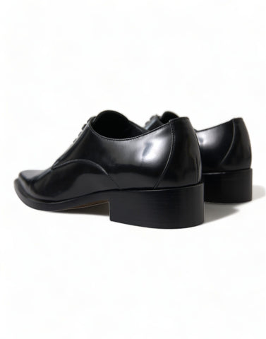 Black leather lace-up formal flats shoes by Dolce & Gabbana, featuring sleek design and elegant craftsmanship.