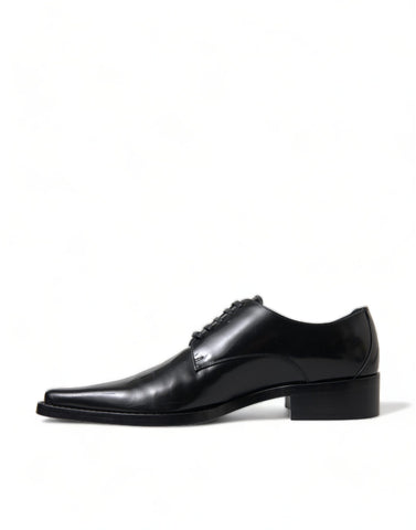 Black leather lace-up formal flats shoes by Dolce & Gabbana, featuring a sleek design and polished finish.