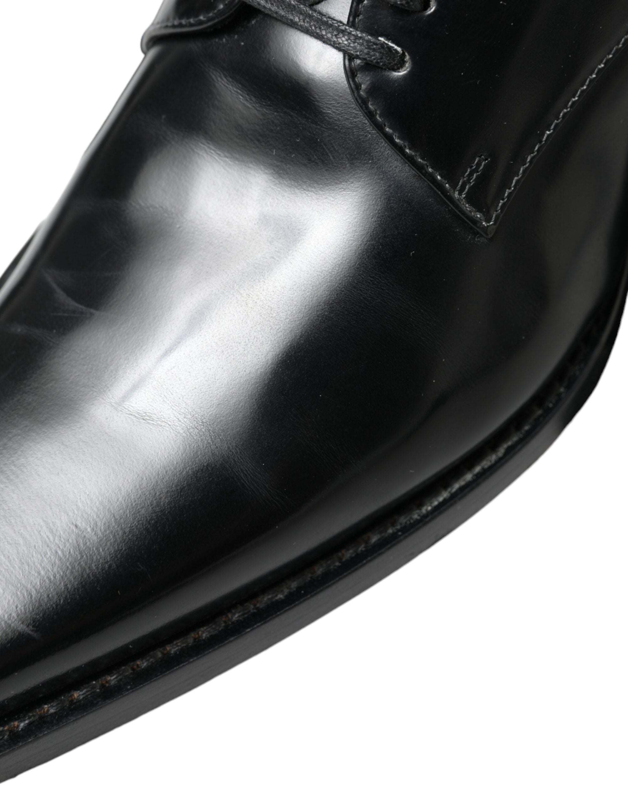 Black leather lace-up formal flats shoes by Dolce & Gabbana, featuring sleek design and classic style.