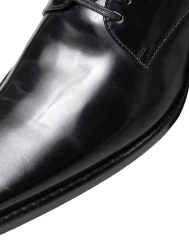 Black leather lace-up formal flats shoes by Dolce & Gabbana, featuring sleek design and classic style.