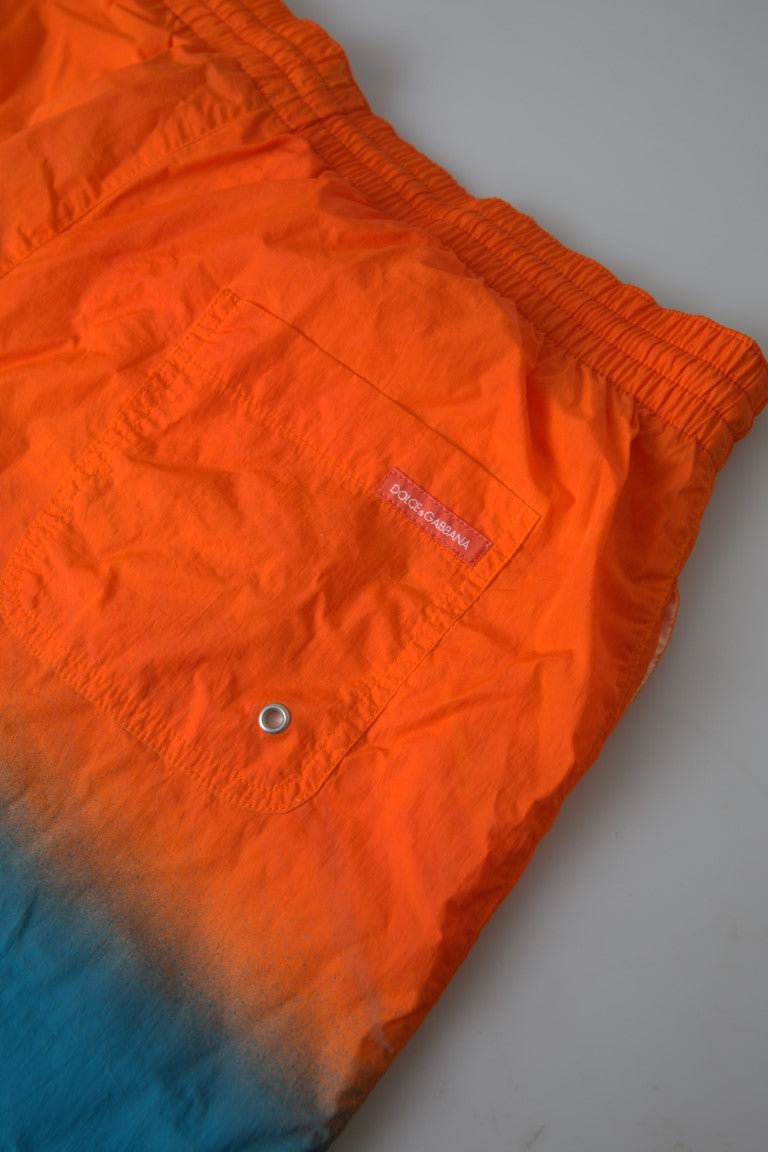 Orange and blue gradient Dolce & Gabbana beachwear swimwear shorts with a stylish, fitted design and lightweight fabric.