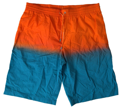 Dolce & Gabbana orange and blue gradient beachwear swimwear shorts laid flat, showcasing stylish summer swim shorts for men.
