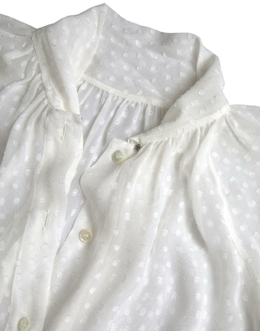 White silk sheer blouse with tied neck and polka dot pattern by Dolce & Gabbana, featuring long sleeves and elegant design