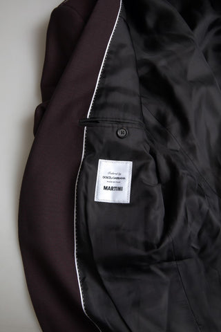 Maroon Dolce & Gabbana 2-piece single-breasted Martini suit displayed on a hanger with fabric details visible