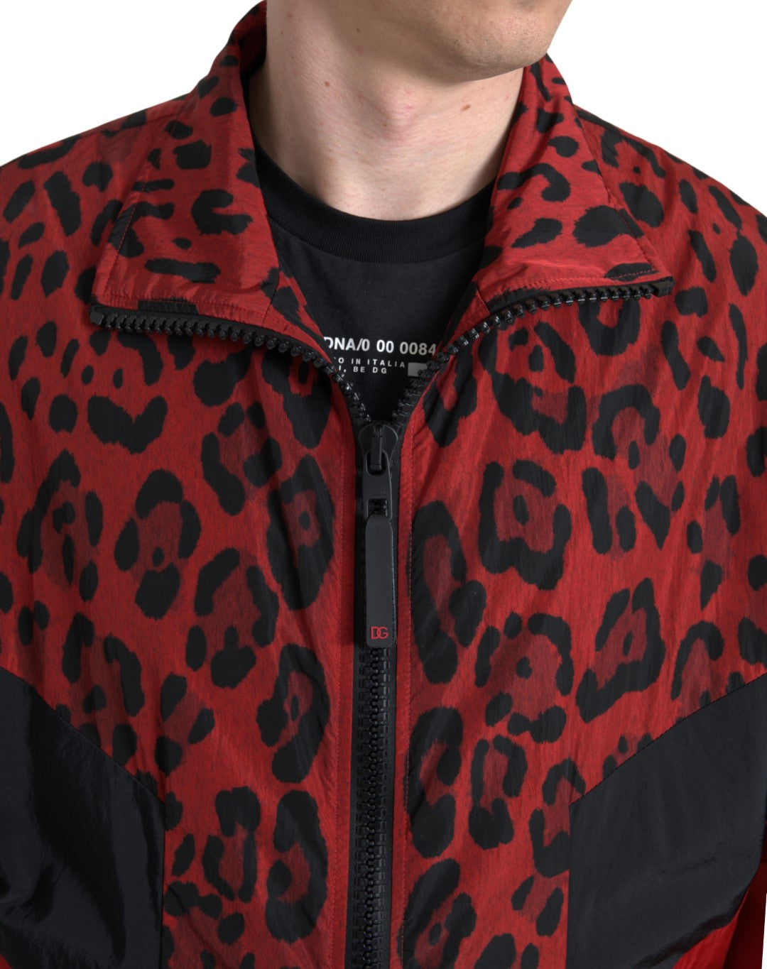 Red leopard print nylon full-zip sweater by Dolce & Gabbana, shown with front view and zipper detail.