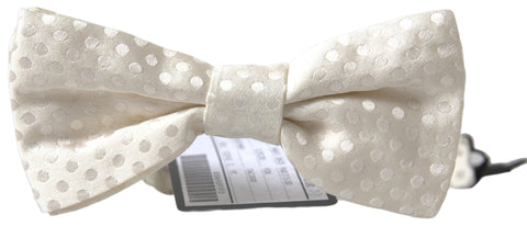 Ivory fantasy pattern adjustable neck papillon bow tie by Dolce & Gabbana, featuring intricate design and classic bow shape.