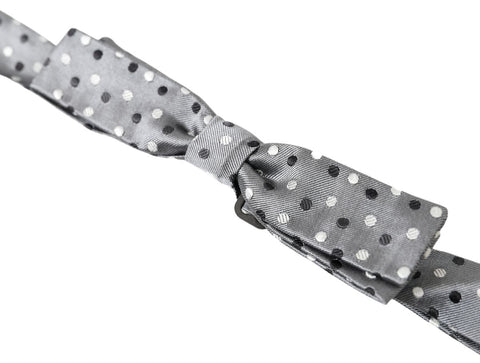 Gray silk polka dot men's adjustable bow tie with papillon style by Dolce & Gabbana, featuring a classic polka dot pattern.