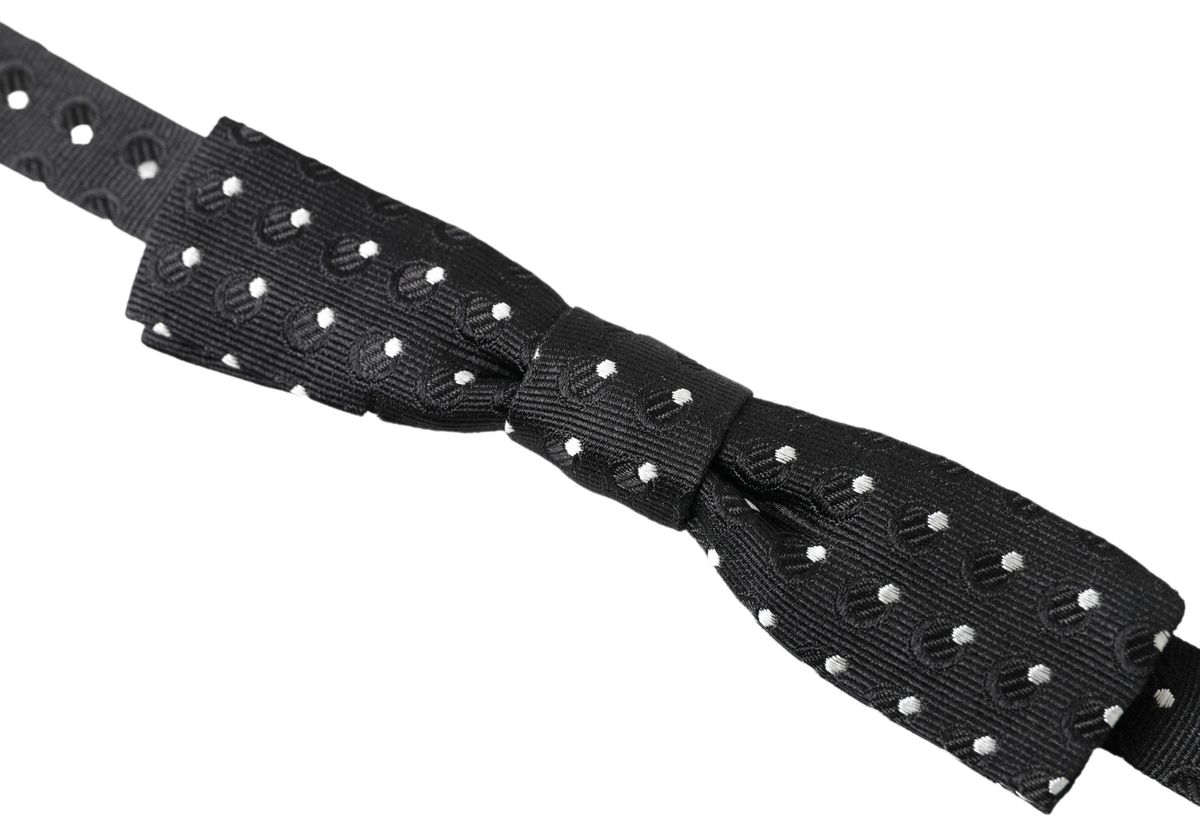 Black polka dot silk adjustable men's bow tie with a papillon style from Dolce & Gabbana, shown tied with classic knot detail.