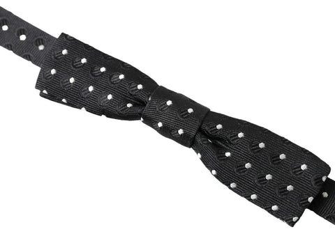 Black polka dot silk adjustable men's bow tie with a papillon style from Dolce & Gabbana, shown tied with classic knot detail.