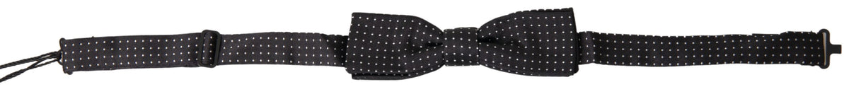 Black silk polka dot adjustable men's bow tie with a papillon style, designed by Dolce & Gabbana, displayed on a plain background.