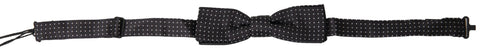 Black silk polka dot adjustable men's bow tie with a papillon style, designed by Dolce & Gabbana, displayed on a plain background.