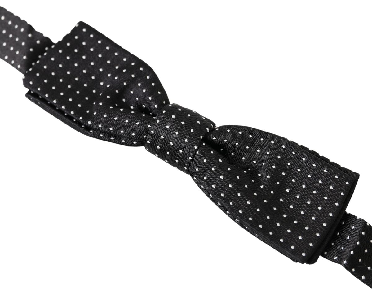 Black silk polka dot men's bow tie with adjustable neck strap by Dolce & Gabbana, featuring classic polka dot pattern and elegant design.