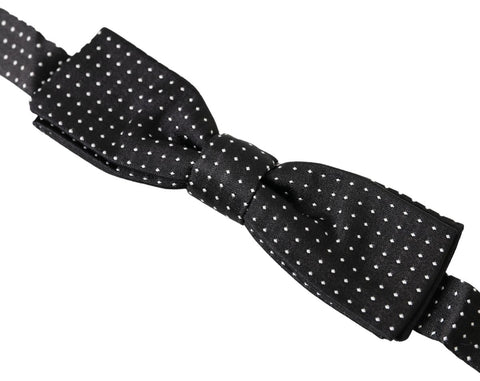 Black silk polka dot men's bow tie with adjustable neck strap by Dolce & Gabbana, featuring classic polka dot pattern and elegant design.