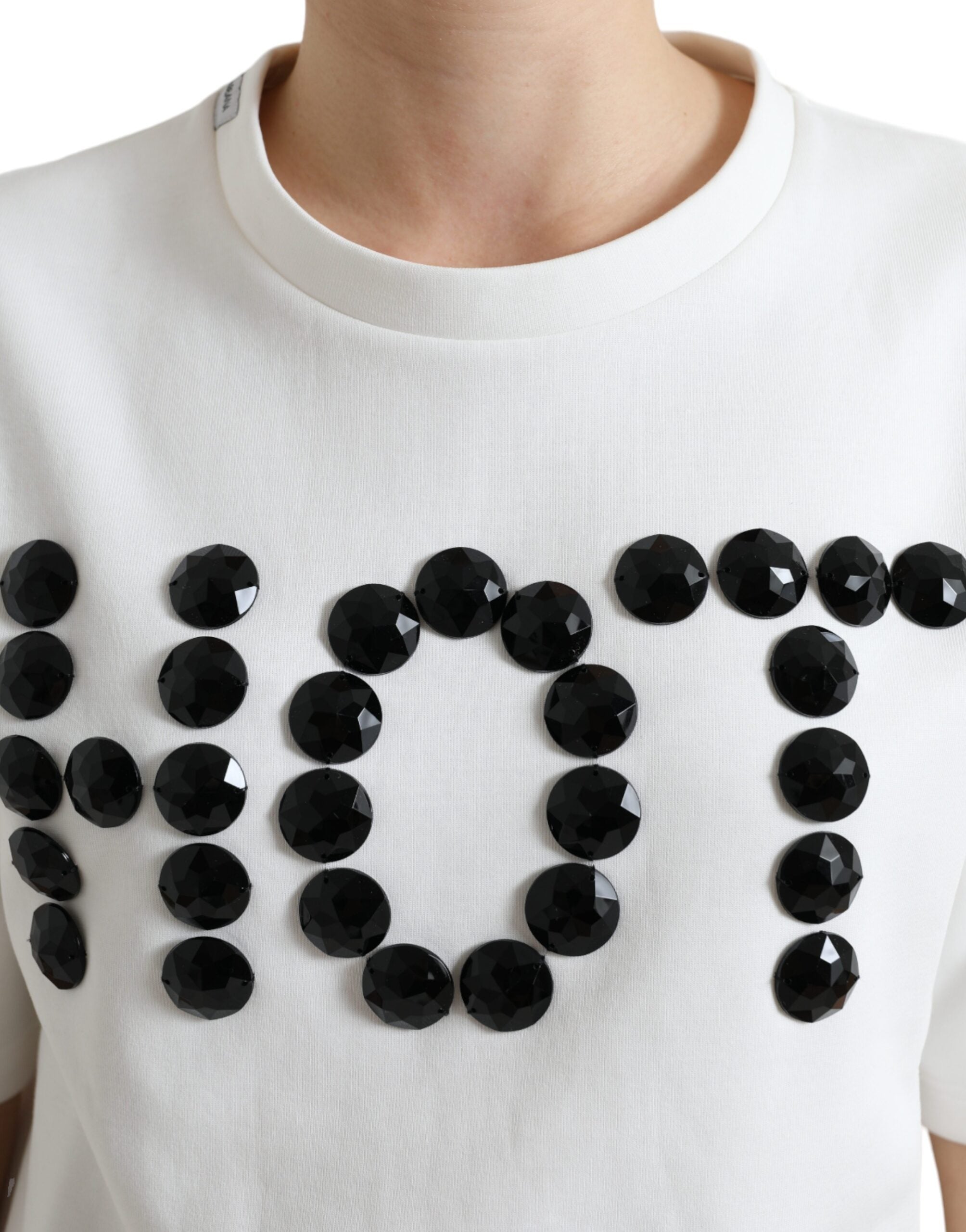 White cotton stretch T-shirt with black hot crystal embellishments by Dolce & Gabbana, shown on a plain background.