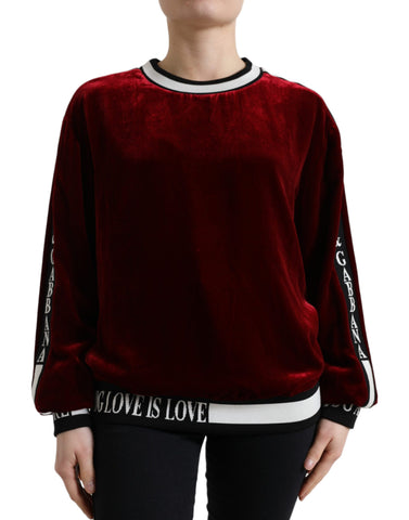 Dolce & Gabbana Bordeaux velvet crew neck pullover sweater displayed on a hanger, showcasing its rich fabric and classic design.